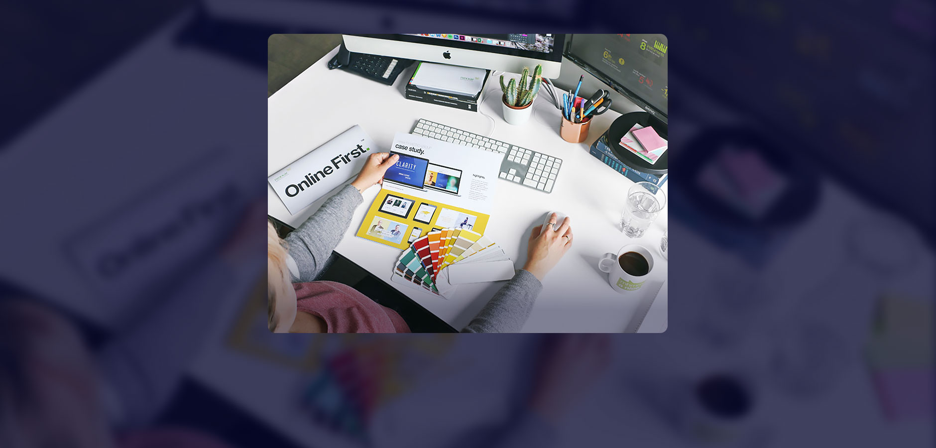 person sitting on by desk, colour matching design to print report (Photo)